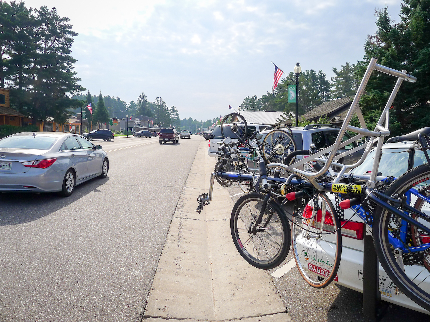 Cars with bike racks parked on street