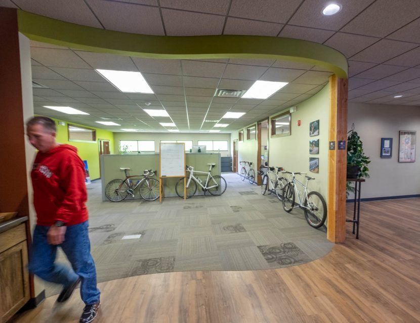 Man walks through Borah Teamwear offices with bicycles in background