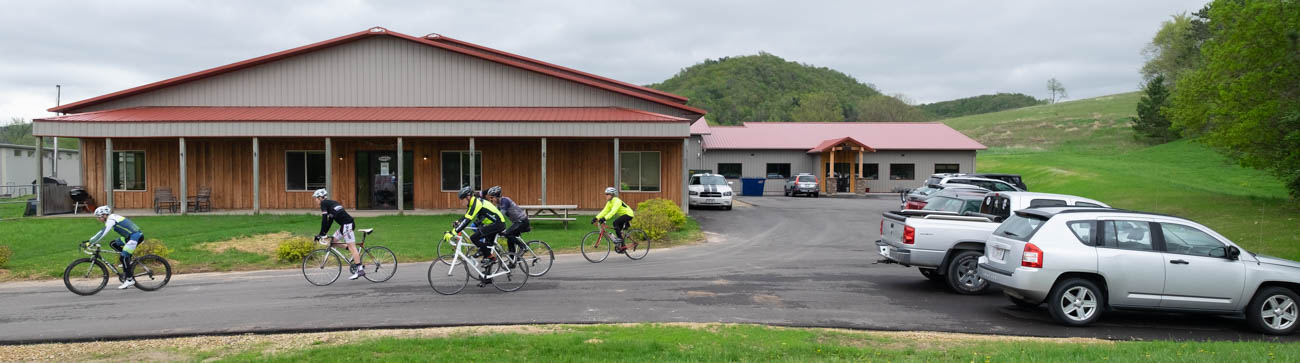 Five people on bikes leave the Borah Teamwear factory for a lunchtime ride