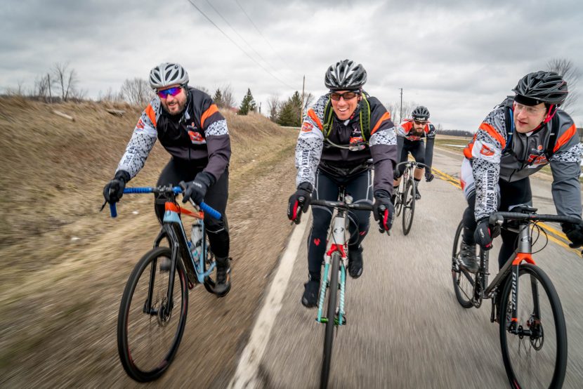 Four cyclists riding next to each other