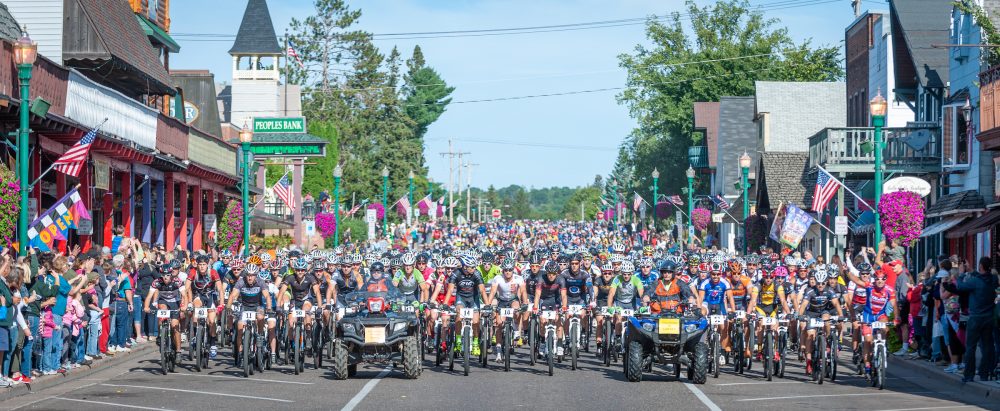 Thousands of mountain bikers are lead by four wheelers down Main Street in Hayward, WI to start the Chequamegon 40 MTB Race