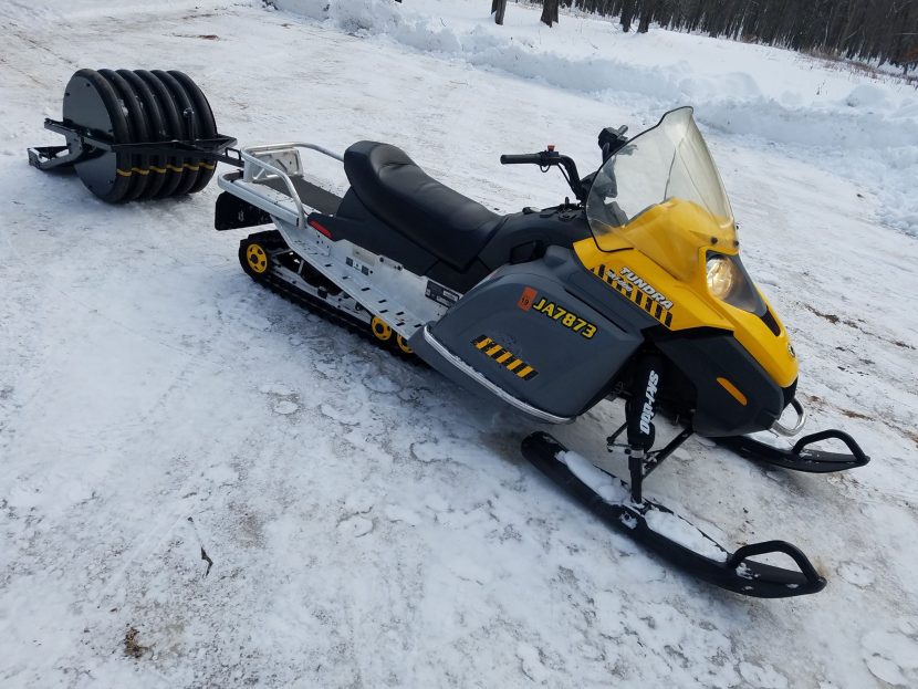 snowmobile with a groomer attached