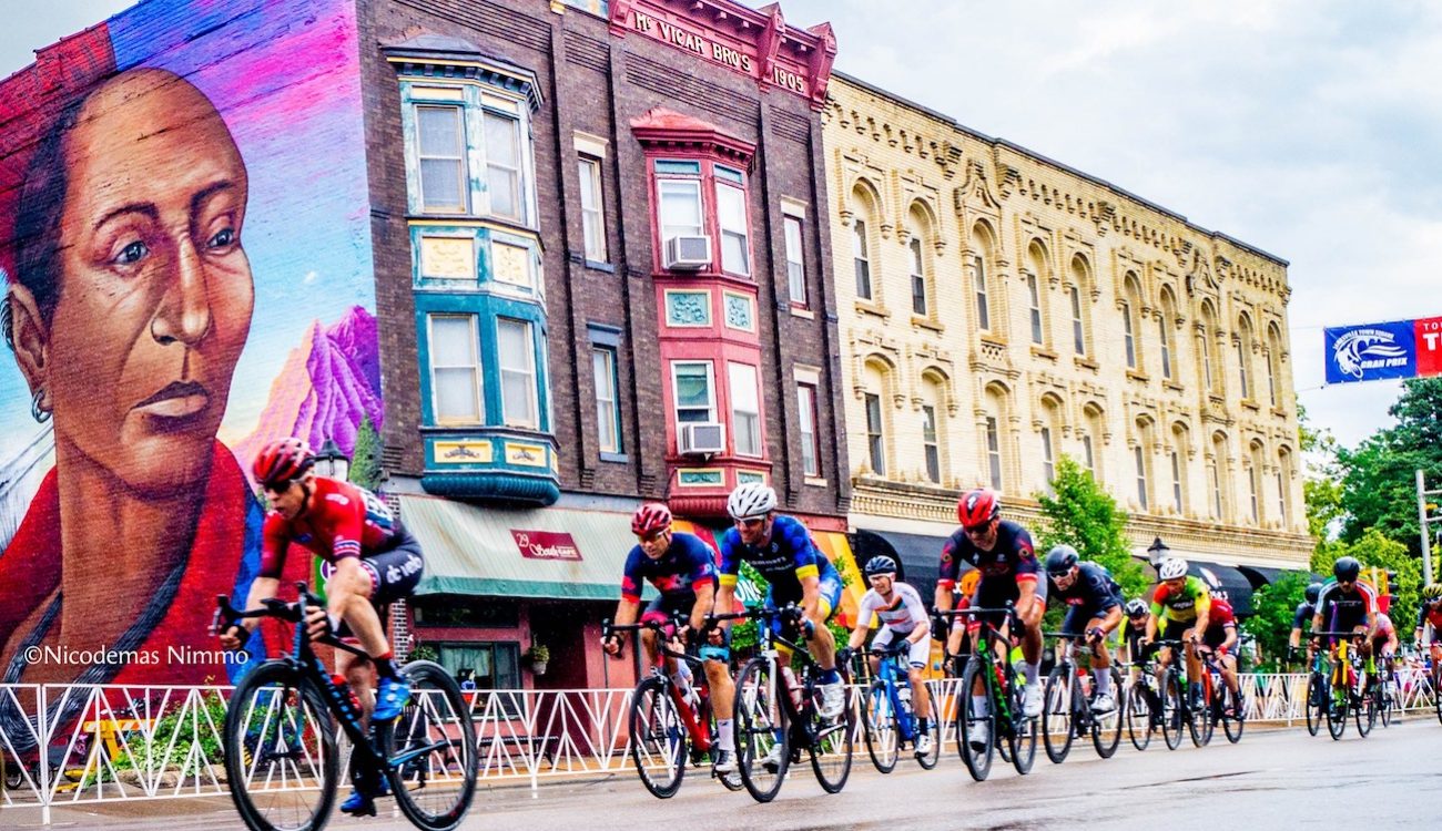 bike racers ride in downtown janesville, wi