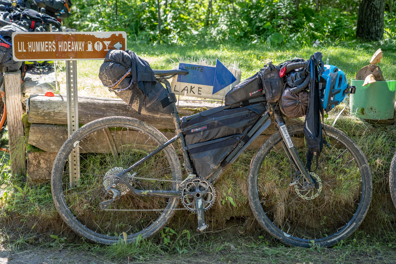 bicycle next to ATV directional signs
