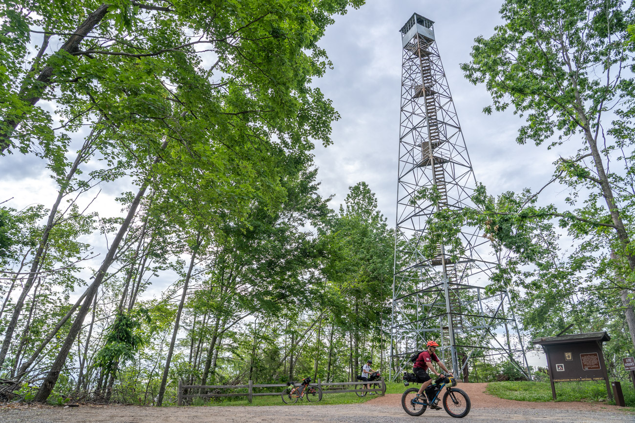 Man rides away from a fire lookout tower