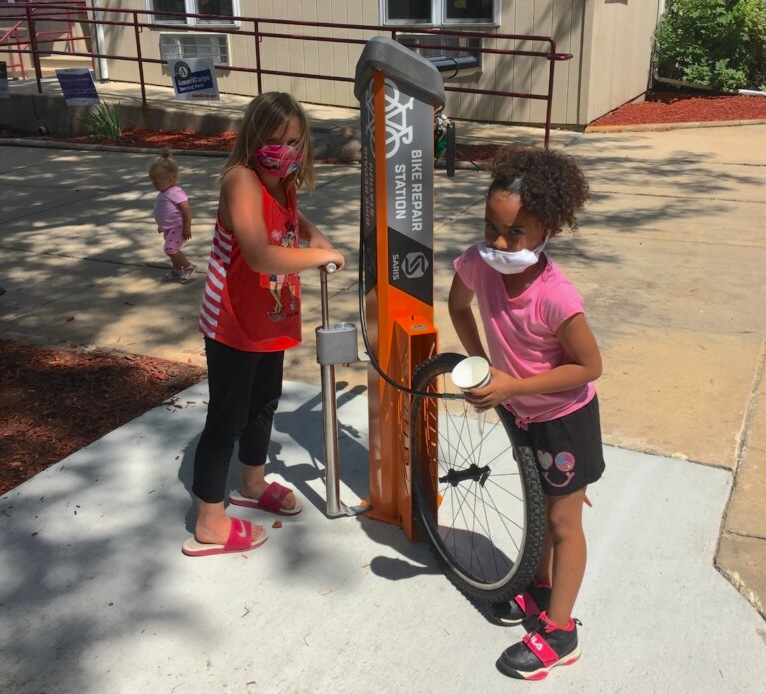 Two young residents learn about the Fix-It station just installed at Kennedy Heights in Madison