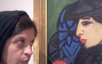 woman looks at painting