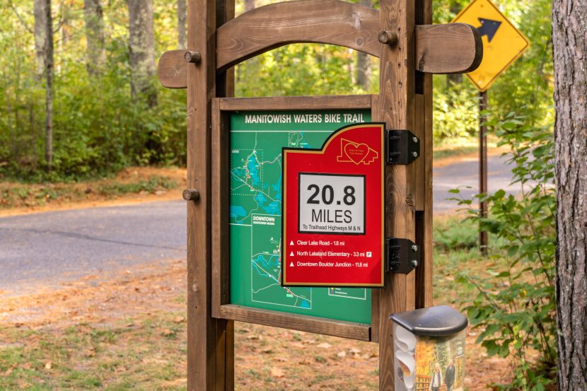 A sign on the Manitowish Waters Bike Trail indicate 20.8 miles distance from the nearest trailhead.