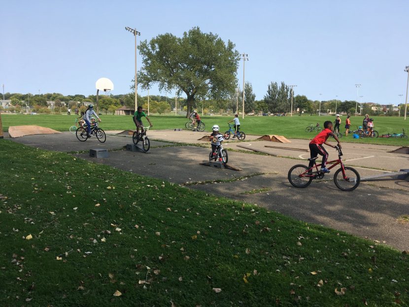 Young riders practice skills on jumps and ramps at Aldo Leopold Park.