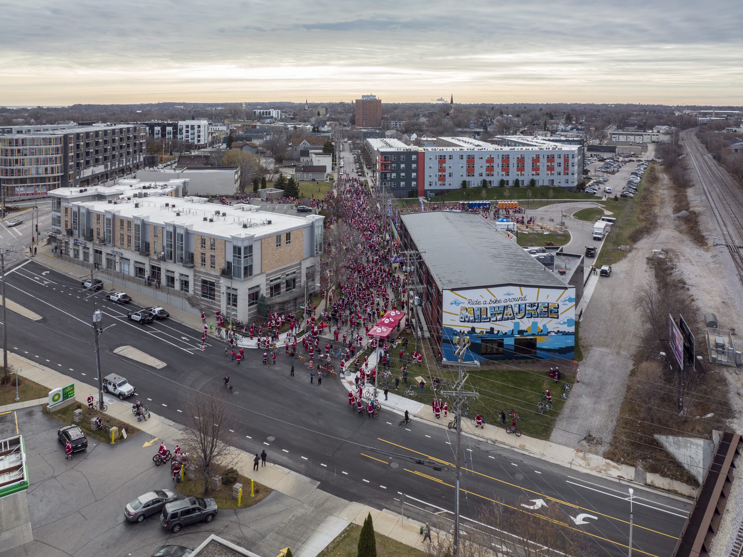 overhead view of 1000 people in santa costumes on bikes