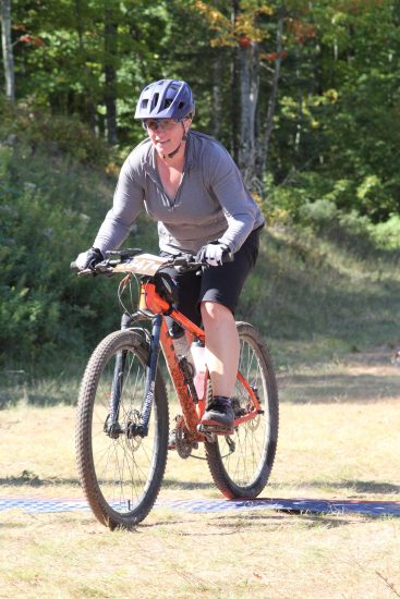 Renee riding a mountain bike on a trail