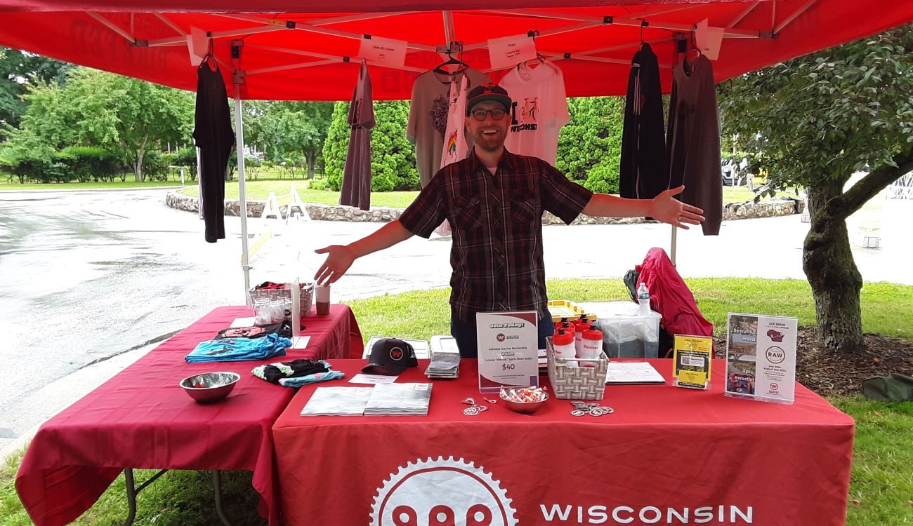 Board member and volunteer Nick welcomes visitors to the Bike Fed booth at Tour of America's Dairyland race in Wauwatosa June 2021