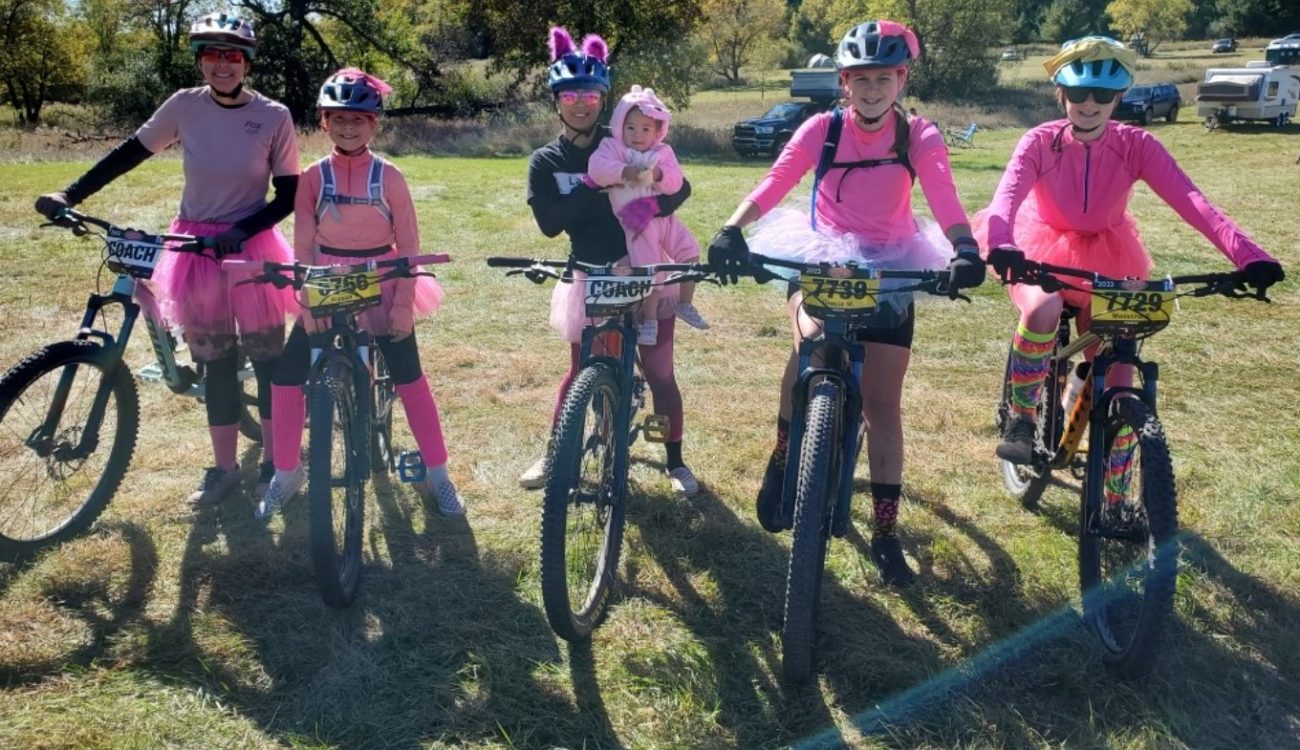 Five cyclists in TuTus plus a baby