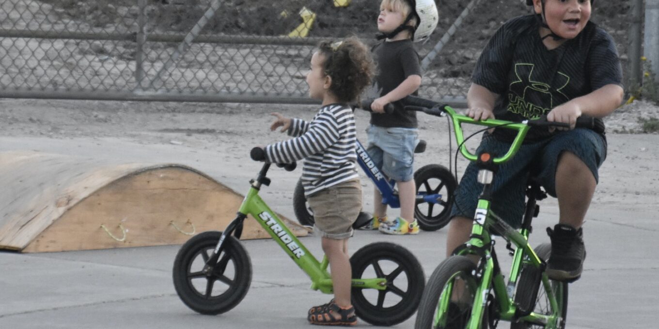 youth learning to ride a bike