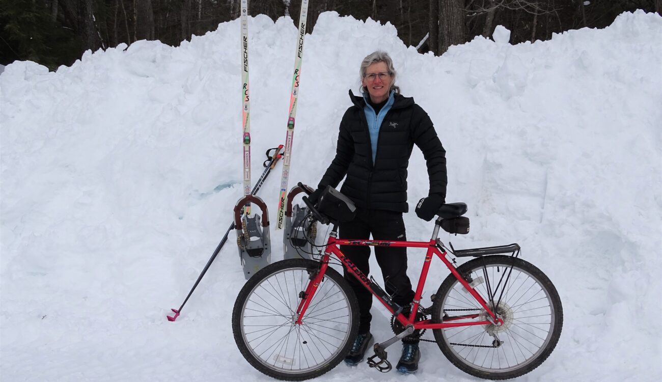 Wendy Stein with bike in front of snow pile