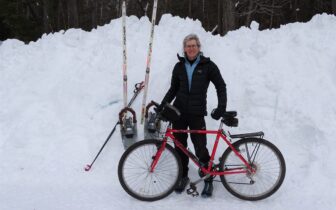 Wendy Stein with bike in front of snow pile