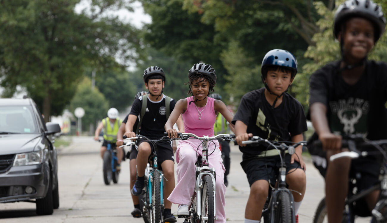 young bike riders in single file facing camera