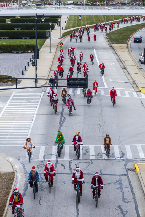 dozens of santa dressed riders are on the streets