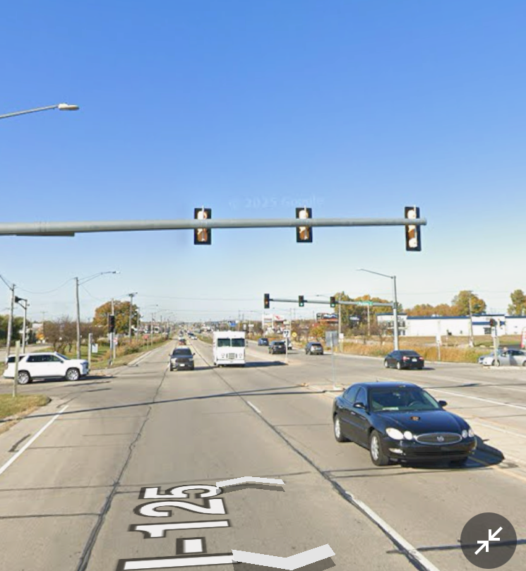 Street view of a wide road with multiple cars