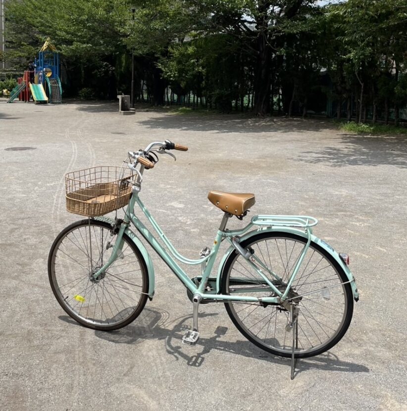 A light green bike in a park